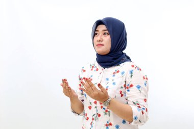 Asian muslim woman standing with pray hand gesture. Grateful concept. Isolated on white background