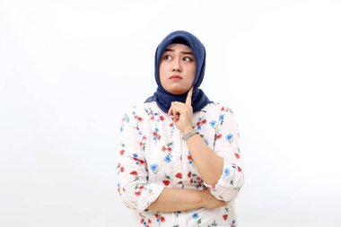 Thoughtful asian muslim woman standing while thinking something. Isolated on white background
