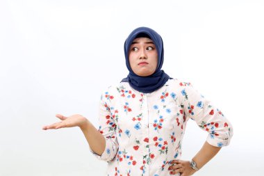 Confused asian muslim woman standing with doubt face expression and gesture. Isolated on white