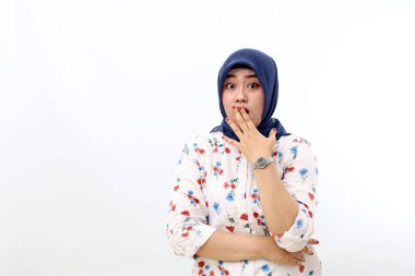 Shocked asian muslim woman standing while covering her mouth. Isolated on white background