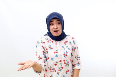 Confused asian muslim woman standing with asking hand gesture. Isolated on white background