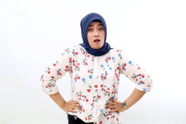 Angry asian muslim woman standing while looking at the camera. Isolated on white background