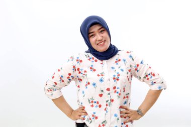 Cheerful asian muslim woman standing while looking at the camera. Isolated on white background