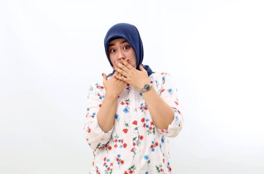 Surprised asian muslim woman standing while covering her mouth. Shocked and unbelief concept