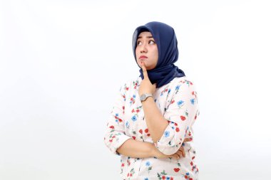 Thoughtful asian muslim woman standing while thinking and imaging something. Isolated on white