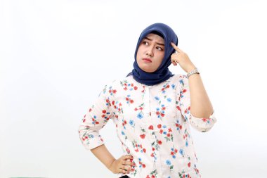 Thoughtful asian muslim woman standing while thinking and imaging something. Isolated on white