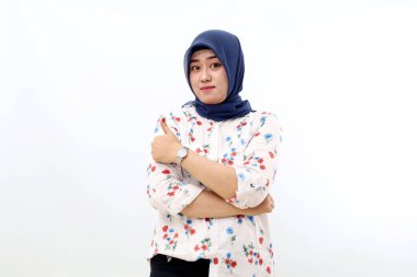 Happy asian muslim woman standing while presenting something and showing thumbs up.Isolated on white