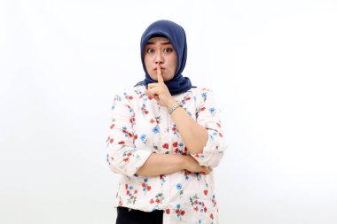 Asian muslim woman standing with silence hand gesture. Isolated on white background