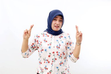 Happy asian muslim woman making hope with her crossed fingers. Isolated on white background
