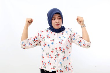 Asian muslim woman standing while making strong gesture and looking sideways. Isolated on white