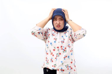 Stressed Asian muslim woman suffering head ache. Isolated on white background