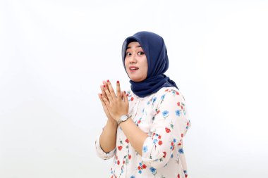 Amazed asian muslim woman standing while looking at the camera. Isolated on white background