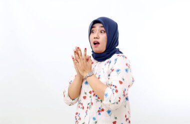 Shocked asian muslim woman standing while looking sideways. Isolated on white background