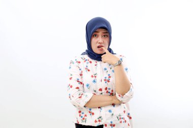 Stressed asian muslim woman standing with scared face expression. Isolated on white background