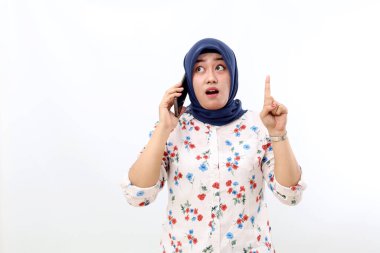 Asian muslim woman getting idea while talking on the phone. Isolated on white background