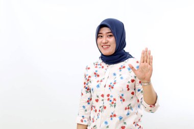 Happy asian muslim woman standing while showing five fingers. Isolated on white background