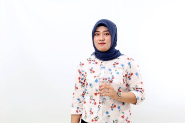 Asian muslim woman standing while holding mineral water, Isolated on white background