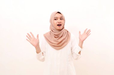 Shocked young asian muslim woman while glancing sideways. Isolated on white background