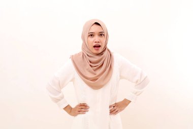 Portrait of young asian muslim woman standing with angry gesture and face expression. Isolated