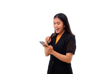 Surprised Young asian business woman standing while holding a cellular phone. Isolated with copyspace