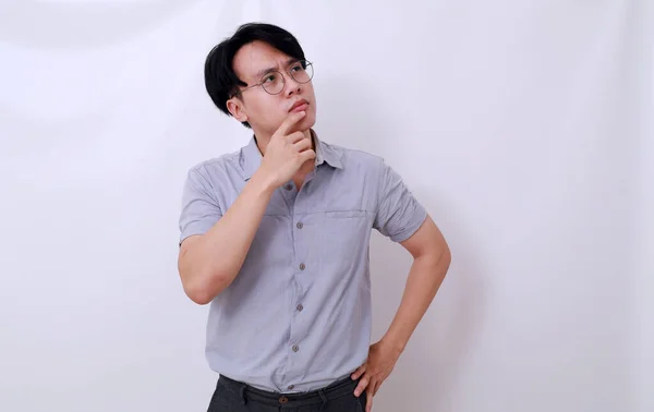 Förvirrad Asiatisk Man Tänker Något Medan Tittar Ovan Isolerad Vit — Stockfoto