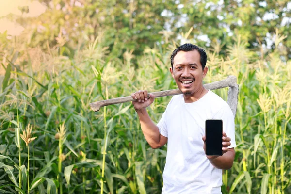 Happy Indonesian Farmer Standing Plantation While Holding Hoe Showing Blank — Stock Photo, Image