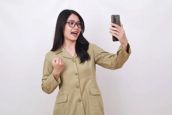 Excited Young Indonesian Civil Servant Woman Holding Cell Phone Fist — Stock Photo, Image