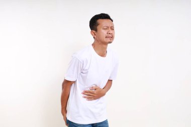 Asian funny man holding his stomach and butt. Diarrhea concept. Isolated on white