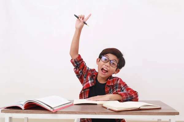 Excited Asian Student Raising His Hand While Studying Isolated White — Stock Photo, Image