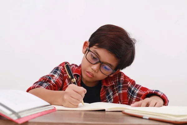 Detailní Fotografie Asijského Studenta Studujícího Tvrdě Stole Izolováno Bílém — Stock fotografie