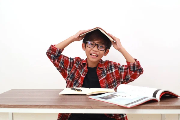 Felice Studente Asiatico Mettendo Libro Sulla Sua Testa Durante Studio — Foto Stock