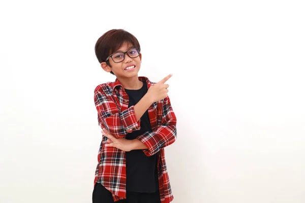 Happy Asian Boy Standing While Pointing Sideways Isolated White Copyspace — Stock Photo, Image