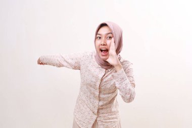 Vay canına, genç Asyalı Müslüman kadının heyecanlı ifadesi arkasında bir şey sunuyor. Beyazda izole edilmiş