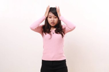 Tired Stressed frustrated young asian girl standing while holding head. Isolated on white background