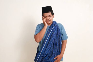 Genç Asyalı müslüman çocuk diş ağrısı çekiyor. Beyazda izole edilmiş