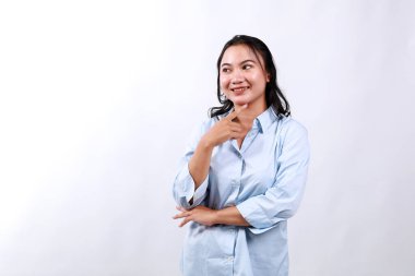 Young asian woman, professional entrepreneur standing in office clothing, smiling and looking at empty space clipart