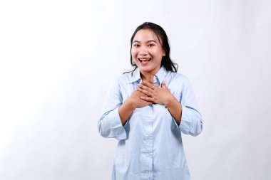 Image of surprised and grateful young woman receive gift, holding hands on chest with flattered smile, saying thank you, being praised, standing over white background. clipart