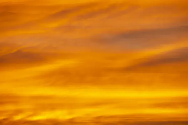 Bright orange evening sky background at sunset