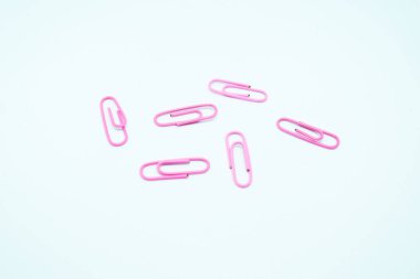 pink paperclips in white background