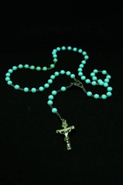 Catholic Rosary Necklace on Black Background