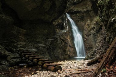 Difficul trail with ladder near the waterfall in canyon of National park Slovak paradise, Slovakia.