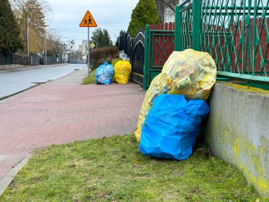 Sorted garbage in plastic bags ready for collection by the garbage truck. Environmental Protection