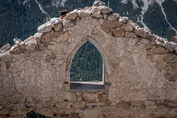An old, destroyed building standing near the trail in the Dolomites. Dolomites, Italy