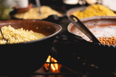 Traditional Mexican Corn Dish Known As Esquites close up, which is corn cooked in chicken broth with epazote herb and seasoned with mayonnaise, shredded white clipart