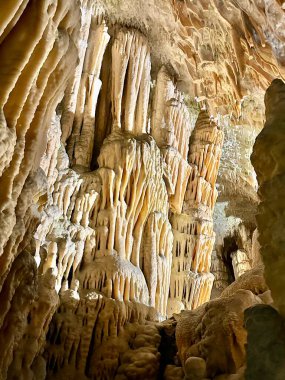 Photography shows closeup of colorful stalactites in the hidden cave clipart