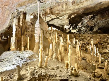 Photography shows closeup of colorful stalactites in the hidden cave clipart