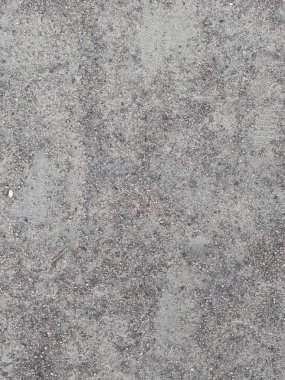 Ayak izleri ve çakıl taşlarıyla dokulu bir Sandy Surface 'in yakın çekimi. Minimalist kaba yüzey, doku, arkaplan, arkaplan, duvar kağıdı