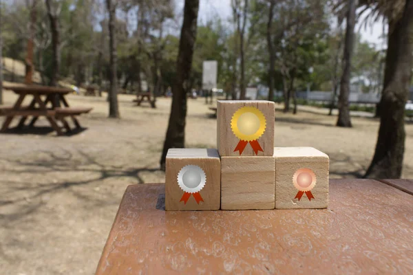 Concept of first, second and third place on a podium of wooden cubes