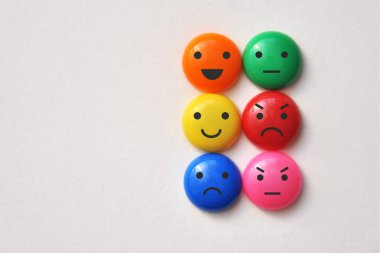 Colorful mugs with drawings of various emotions: sadness, anger, calmness. Emotions in people's live