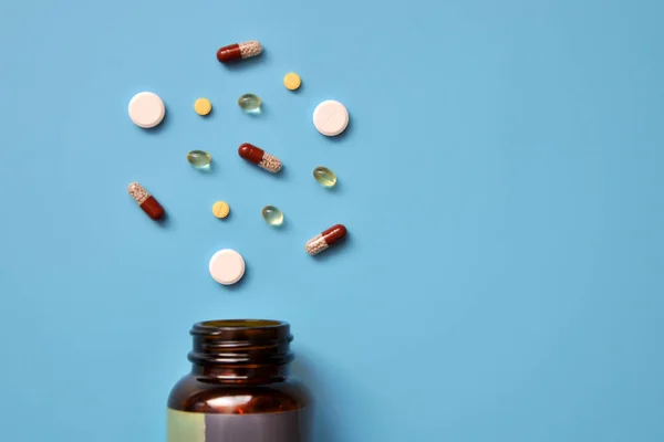 tablets, capsules, vitamins are scattered from a medical jar